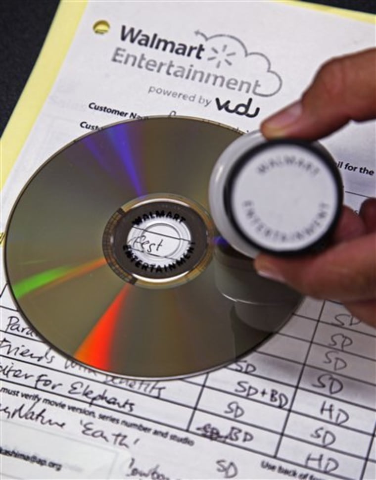 A "Walmart Entertainment" stamp in indelible ink has been placed on a disc, preventing any further conversion, but allowing it to still be played, at a Wal-Mart store in Rosemead, Calif., Wednesday, April 11, 2012. 
